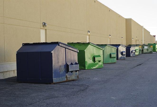 a stack of yellow construction dumpsters on a job site in Ashland